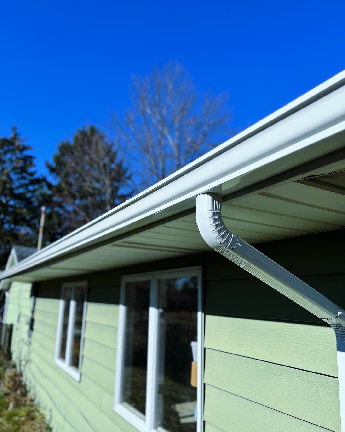 Seamless white aluminum gutter installation by Zipco Gutters